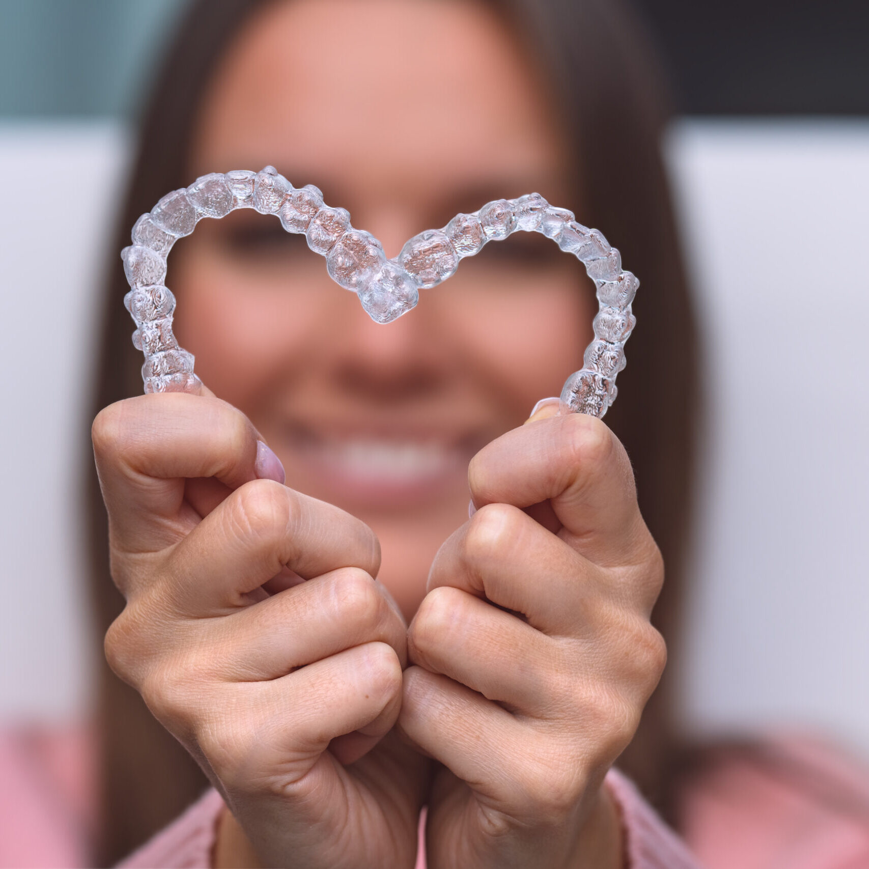 Woman with dental invisible invisalign braces or silicone trainer. Aligners treatment. High quality photo